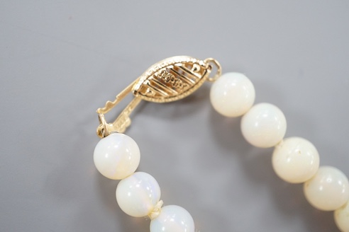 A modern single strand white opal bead necklace, with 585 yellow metal clasp, 44cm.